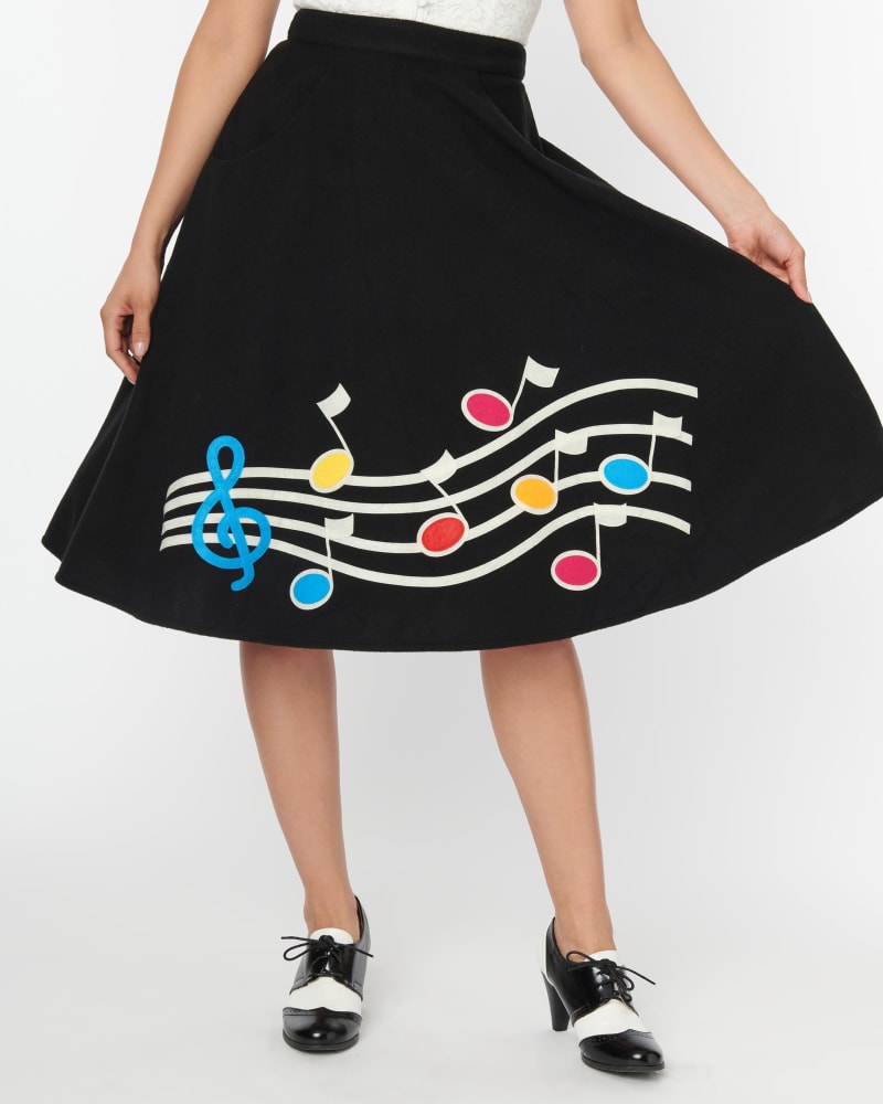 Side of a model wearing a size 5X/26 Unique Vintage Black Musical Note Soda Shop Swing Skirt in Black Musical Note by Unique Vintage. | dia_product_style_image_id:269744